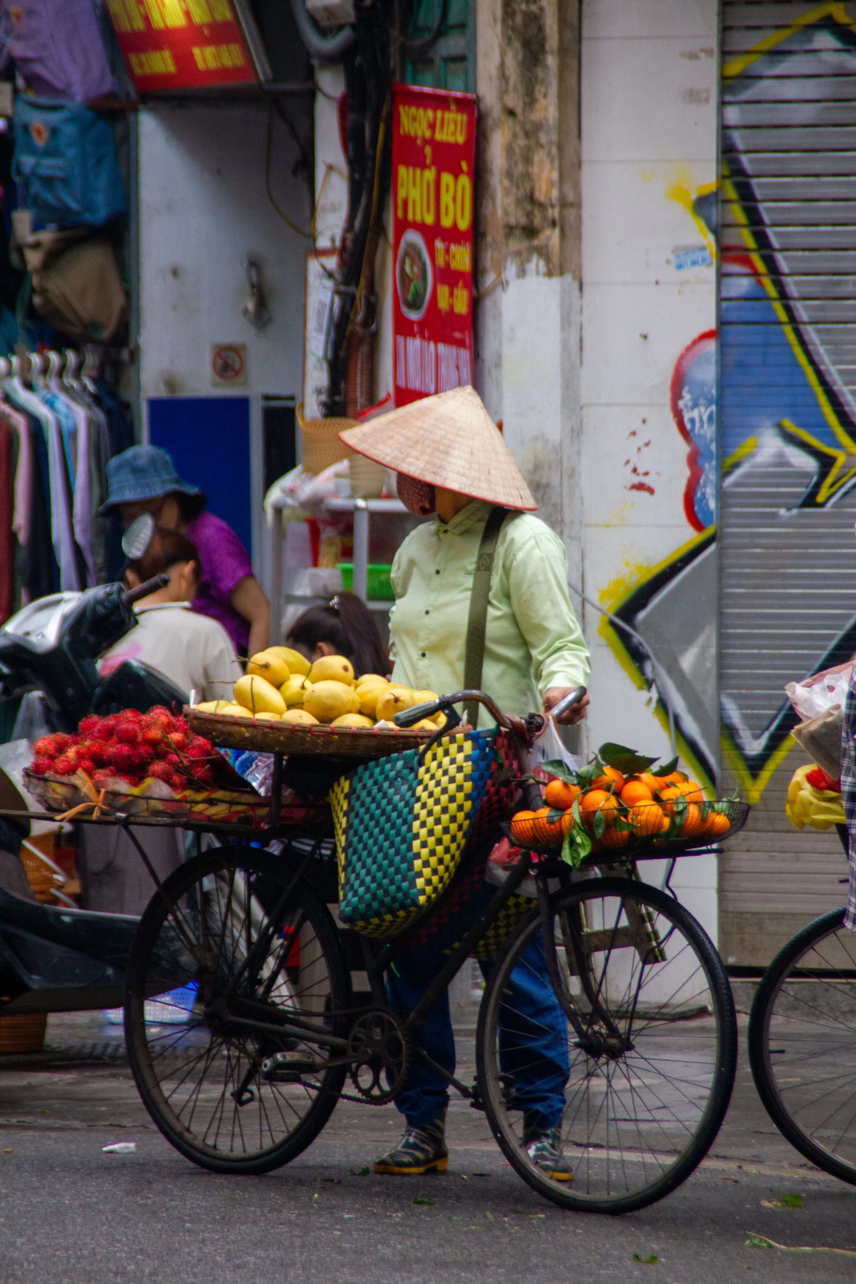 Merchant carrying her produce on the her bike